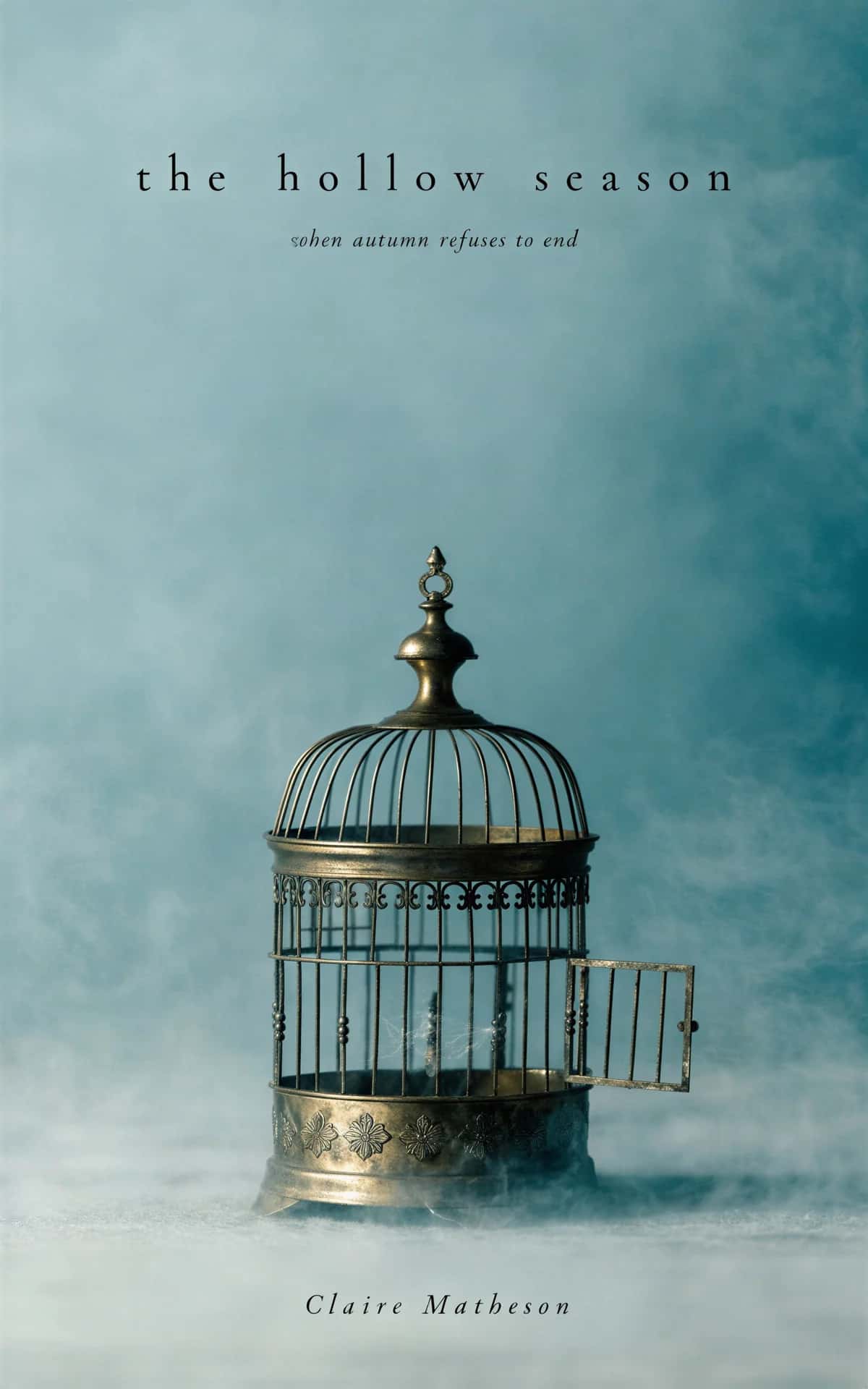 AI book cover generator horror quiet-minimal-menace: ornate brass birdcage with open door in misty atmosphere for "The Hollow Season"